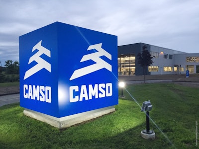 The new brand logo is seen here in a nighttime photo of the sign outside a company plant. Camso calls itself the “Road Free Company.” Photo: Camso