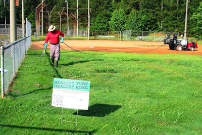 A volunteer from the Smyrna, Georgia, branch of ValleyCrest Landscape Maintenance makes a weed-control application to the outfield of a ball field at Fair Oaks Park during the “Healthy Turf Healthy Kids” renovation project. Photo: Project EverGreen