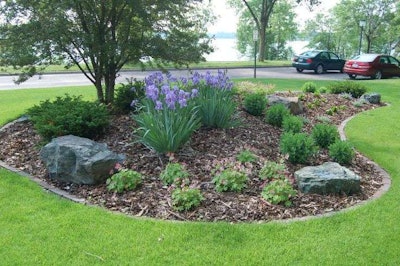 A berm can serve as a way to redirect rainwater and be a beautiful lawn element. Photo: bachmanslandscaping.com