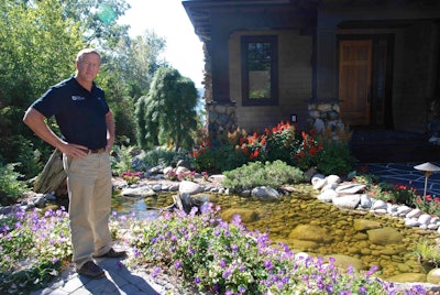 Standing beside one of the water features for which his company is known, Bob Drost is quick to credit his success to the talent and drive of his employees. Photo: Lauren Heartsill Dowdle