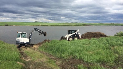 Unbothered by cloudy skies, volunteers keep Terex compact equipment humming as restoration work continues. Photo: Terex