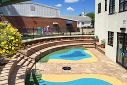 The 540-square-foot, semi-circular safety surface play area is constructed of poured-in-place Vitriturf rubber and features a blue, green and yellow pattern reminiscent of a lake with a beach and a meadow. Photo: Peter Wilk/Wilk Marketing Communications