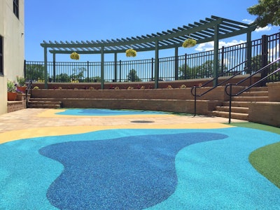 The southwestern perimeter of the Children’s Program Area features a 40-foot long, 8-foot wide radial pergola with a trellis. Two 70-foot long retaining walls are built into the slope of the site and provide comfortable seating for library patrons. Photo: Peter Wilk/Wilk Marketing Communications