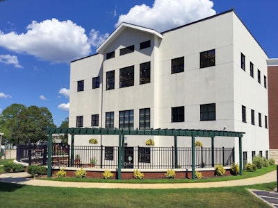 Adjacent to the southwestern wall of the Sayville Public Library building, the semi-circular Children’s Program Area has replaced an underutilized, sloping lawn and is the library’s only outdoor venue. Photo: Peter Wilk/Wilk Marketing Communications