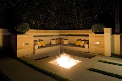 This in-ground fire pit is surrounded by hardscaping and built-in furniture, reducing the risk of a fire-related accident. Photo: cubeworld.co