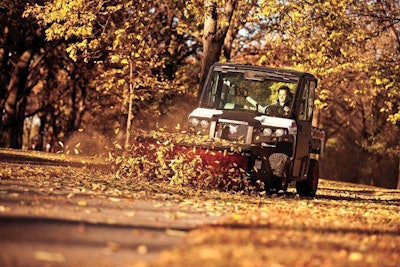 The broom attachment for this Bobcat 3650 utility vehicle angles up to 25 degrees right or left. Among other tasks, landscape contractors can use it to sweep leaves and debris from commercial clients’ parking lots and sidewalks. Photo: Bobcat