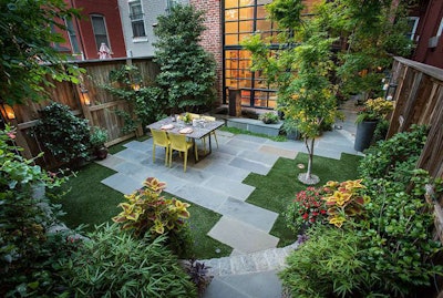 The design of this small backyard packs greenery, hardscaping and seating into a 22-by-22-foot area. Photo: Botanical Decorators
