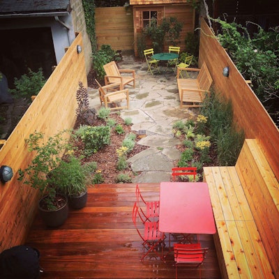 This longer garden is broken into different areas with the use of contrasting hardscapes. Photo: New Eco Landscapes