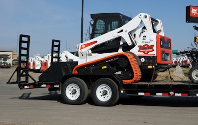 Once the machine is loaded, lower the attachment to the floor of the trailer and secure chains according to your owner’s manual. Photo: Bobcat