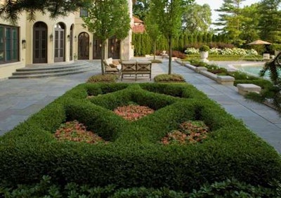 Geometric greenery was used in the design, along with a few carefully chosen sculptures and pergolas. Photo: Linda Oyama Bryan
