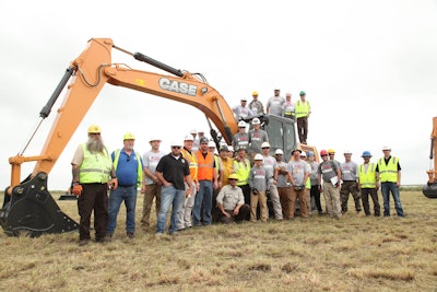 Participants in the project pose beside one of the half-dozen machines provided by Case. Photo: Case Construction Equipment