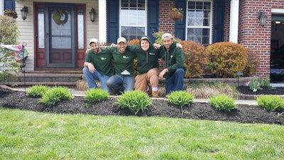 Kirk Brown, second from left, poses with his crew members. Kirk’s Lawn Care has grown steadily and Brown hopes to hire two more people next year.