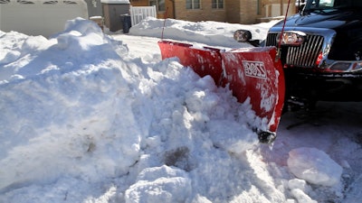 A Project EverGreen SnowCare for Troops volunteer makes a difference for a military family or wounded or disabled veteran last winter by removing snow from their home. Photo: Project EverGreen
