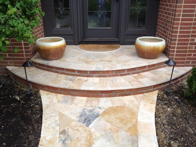 Travertine can often be found around pool deck areas, but can also brighten up a walkway. Photo: Two Brothers Brick Paving