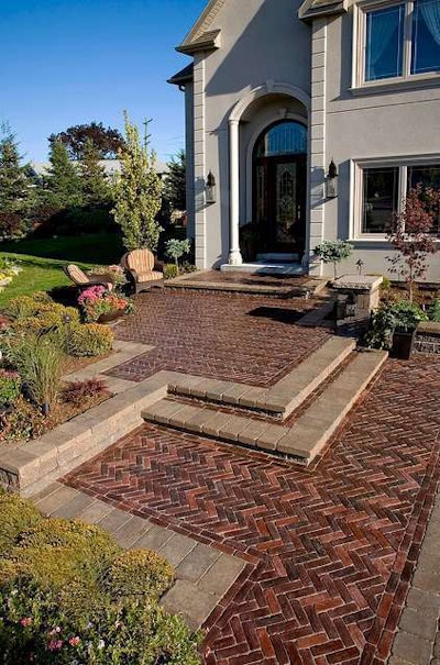 This brick front entrance features the herringbone pattern. Photo: Unilock