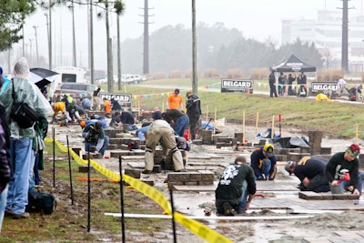 The competition is tough and sometimes so are the conditions under which it’s staged. Students in this hardscaping challenge during a prior year’s event had to overcome the rain and mud as well as the competition. Photo: NALP