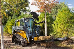 The NF44 can carry up to 3,000 pounds and is equipped with one stationary arm and a second arm that has the ability to swing open and then close on the load. Photo: John Deere