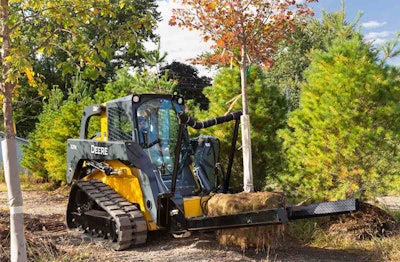 The NF44 can carry up to 3,000 pounds and is equipped with one stationary arm and a second arm that has the ability to swing open and then close on the load. Photo: John Deere