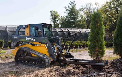 The nursery fork can transport and position up to 44-inch balled or container trees, shrubs, rocks and light boulders. Photo: John Deere
