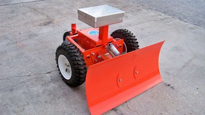 Shown here with the snow-plow attachment, the MAGA robot is operated with a remote control, requiring only one finger to manipulate, according to the manufacturer. Photo: Evatech