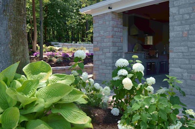 The outdoor kitchen visible here may have been the highest value-add on the project, but the series of raised beds and their plantings illustrate the company’s broad skillset.
