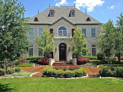 This home’s driveway features a decorative, stained surface from Concrete Craft. Photo: Concrete Craft
