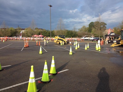 Judges watch closely Friday morning as a competitor attempts to pick up a pallet containing a bucket of water before completing a series of tasks. Photo: Jill Odom