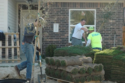 Volunteers from Project EverGreen, Turfgrass Producers International, the Brickman Group and Habitat for Humanity Houston lay sod and plant trees for five new homes. Photo: Project EverGreen