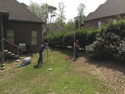 Jeff Brannen, a supervisor with Andy’s Landscape Service, works with designer Jennifer Ferguson at a project that will involve major grade work. Ferguson said the client may choose to overcome the site’s challenges by separating the backyard into tiers. Photo: David Rountree