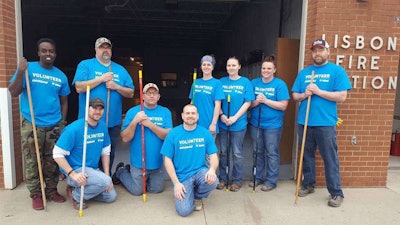 Approximately 100 Doosan and Bobcat Co. volunteers participated in 10 projects in and near Gwinner, in southeastern North Dakota. Here, a few miles north of Gwinner, in Lisbon, volunteers helped paint the floor at the Lisbon Fire Department. Photo: Bobcat