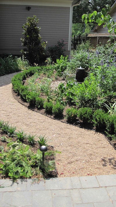 A gravel path curves around a bird sanctuary installed by Ravenscourt Landscaping and Design Photo: Ravenscourt Landscaping and Design