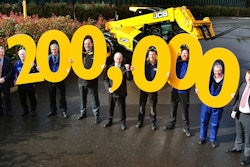 Flanked by managing director Ian Pratt on the far left and operations director Paul Grys on the far right, JCB employees joining in the Loadall celebration are, from left, Ian Vickery, Cliff Ferrie, Mick Smith, Dave Bailey, Nick Miller, Paul Stockley and Richard Jenkinson. Photo: JCB