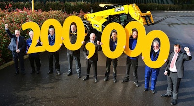 Flanked by managing director Ian Pratt on the far left and operations director Paul Grys on the far right, JCB employees joining in the Loadall celebration are, from left, Ian Vickery, Cliff Ferrie, Mick Smith, Dave Bailey, Nick Miller, Paul Stockley and Richard Jenkinson. Photo: JCB