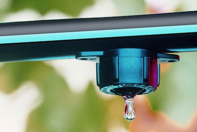 Water drips from an emitter on this irrigation system from Toro. Drip irrigation is especially effective in helping young plants become established in the landscape. Photo: Toro