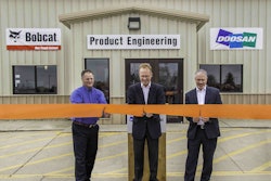 Rich Goldsbury, middle, president of Bobcat and Doosan North America and Oceania, was joined recently by Gwinner Mayor Dan McKeever, at left, and members of the Gwinner City Council for a ribbon-cutting ceremony at the engineering facility. Photo: Bobcat