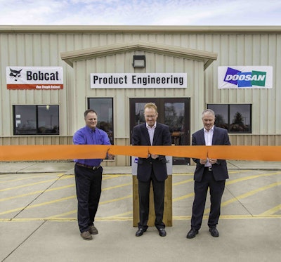 Rich Goldsbury, middle, president of Bobcat and Doosan North America and Oceania, was joined recently by Gwinner Mayor Dan McKeever, at left, and members of the Gwinner City Council for a ribbon-cutting ceremony at the engineering facility. Photo: Bobcat