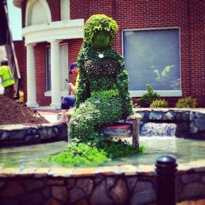 A mermiad topiary from last year ruminates in the pond. Photo: South Carolina Festival of Flowers