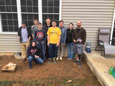 Several of the students who worked on the project pause for a photo with Vince Reynolds (far right). Photo: EP Henry