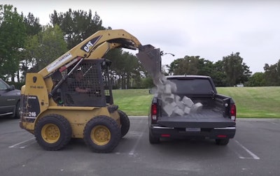 Not to be forgotten as Chevrolet and Ford fight it out on social media, Honda rented a skid steer to dump 800 pounds of rough-cut concrete blocks onto the bed of a Ridgeline pickup. Photo: Honda