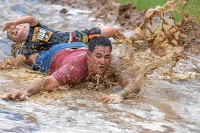 Not far from the finish line, an oversize mud slide was a hit with participants and spectators alike. Photo: JCB