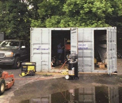 The landscaping company was working out of several storage containers in the parking lot of a furniture store. Photo: The Island Now
