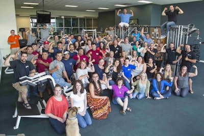 Aquascape employees show off their muscles after the company is declared one of the healthiest in America. Photo: Aquascape Inc.