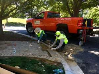 Volunteers from Sunrise Landscape and Design handled a number of jobs, including the repair and replacement of a sidewalk in the historic national cemetery. Photo: Jill Odom