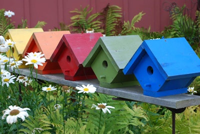 Birdhouses provide easy pops of color that can be quickly changed with a new coat of paint. Photo: njenney/Flickr