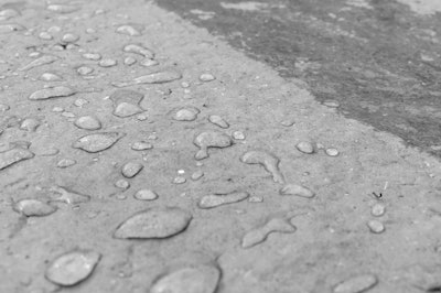 This before/after photograph shows the results of using AQUA-XTM 11 sealer on a concrete surface. Photo: Black Diamond Coatings