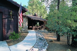 Using a concrete pathway and a fuel break of stone helps prevent fire from reaching a home. Photo: Firewise.org