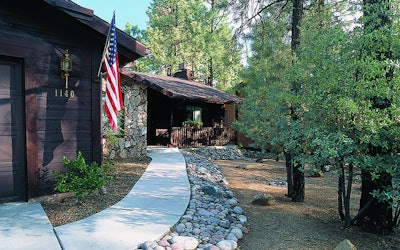 Using a concrete pathway and a fuel break of stone helps prevent fire from reaching a home. Photo: Firewise.org