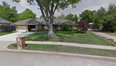 The client’s house before the renovation had a large tree that dominated the yard.