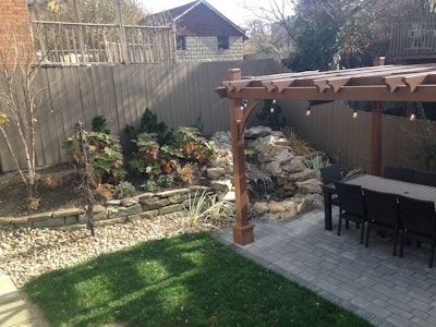 This project managed to fit a pergola, a water feature, and a fire feature in small space.