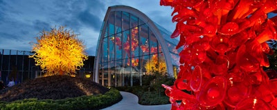 One of the garden’s ‘anchor’ sculptures, The Sun, looks down on the landscape and artwork at Chihuly Garden and Glass in Seattle. Photo: Chihuly Garden and Glass